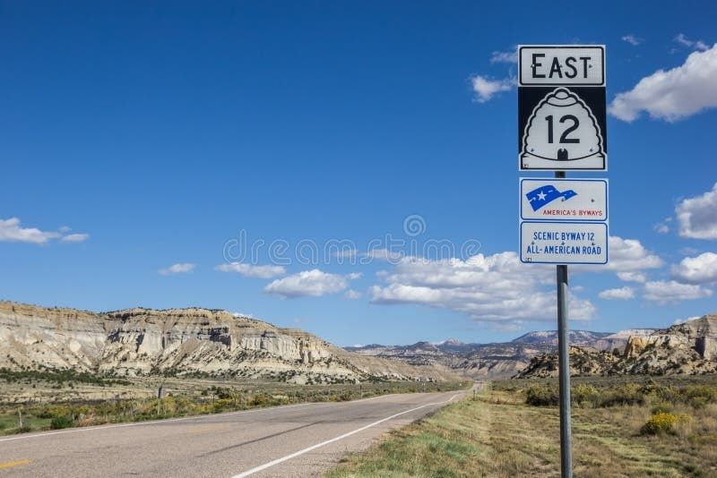Eastbound Scenic Byway 12 sign beside an open road in rugged terrain